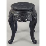 A SMALL CHINESE EBONISED HARDWOOD STAND, with carved frieze supported on four curving legs, top