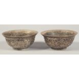 A PAIR OF CHINESE SILVERED METAL BOWLS, decorated with chilong, each with four-character marks to