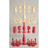 A COLLECTION OF CARVED AND STAINED BONE CHESS PIECES.