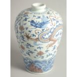 A CHINESE BLUE, WHITE, AND UNDERGLAZE RED PORCELAIN MEIPING VASE painted with a dragon and phoenix
