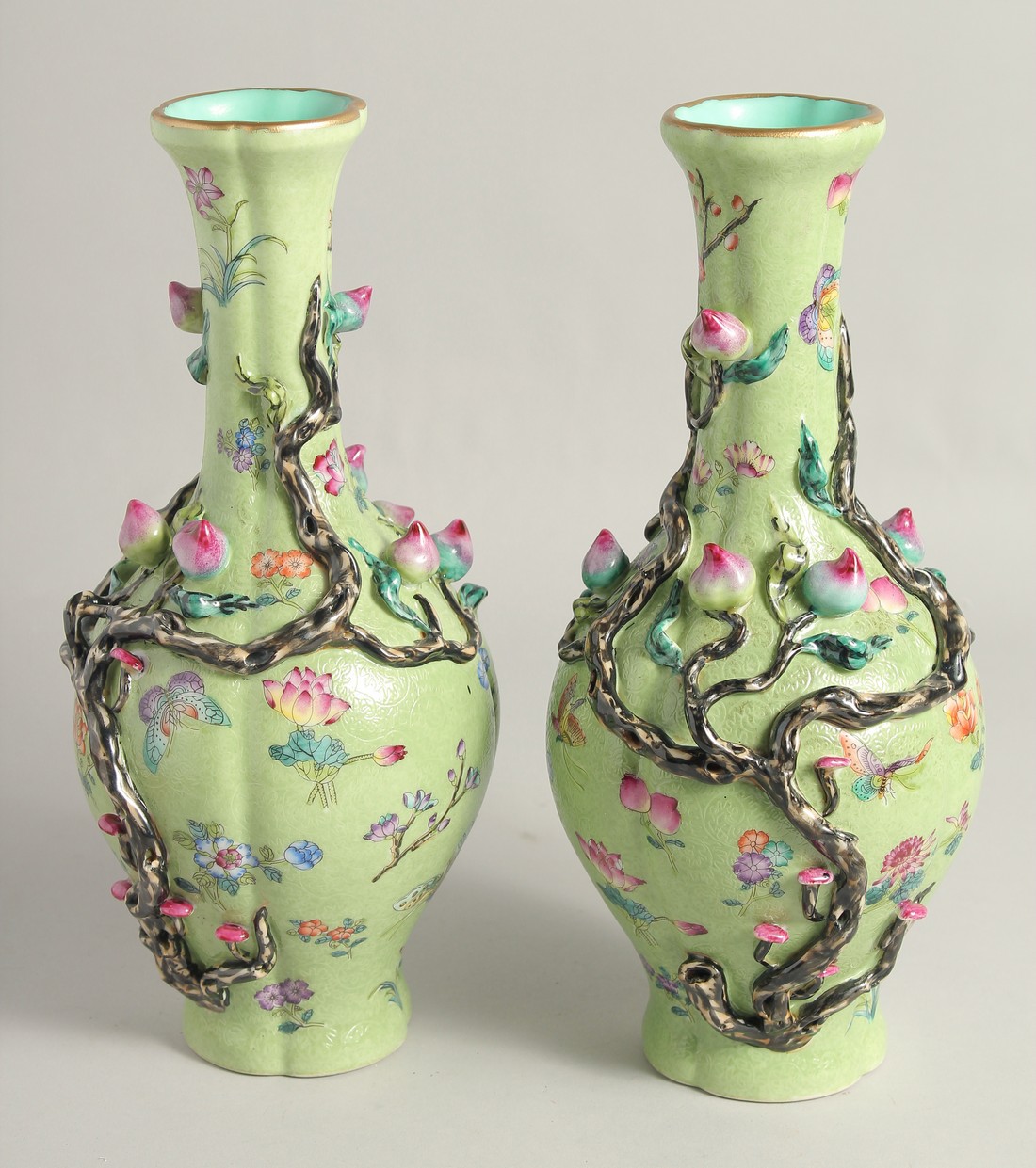 A PAIR OF CHINESE GREEN GROUND PORCELAIN VASES, with relief peach blossom and further decorated with - Image 4 of 8