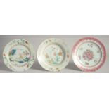 THREE CHINESE FAMILLE ROSE PORCELAIN PLATES, one painted with a crane and flora, another with a