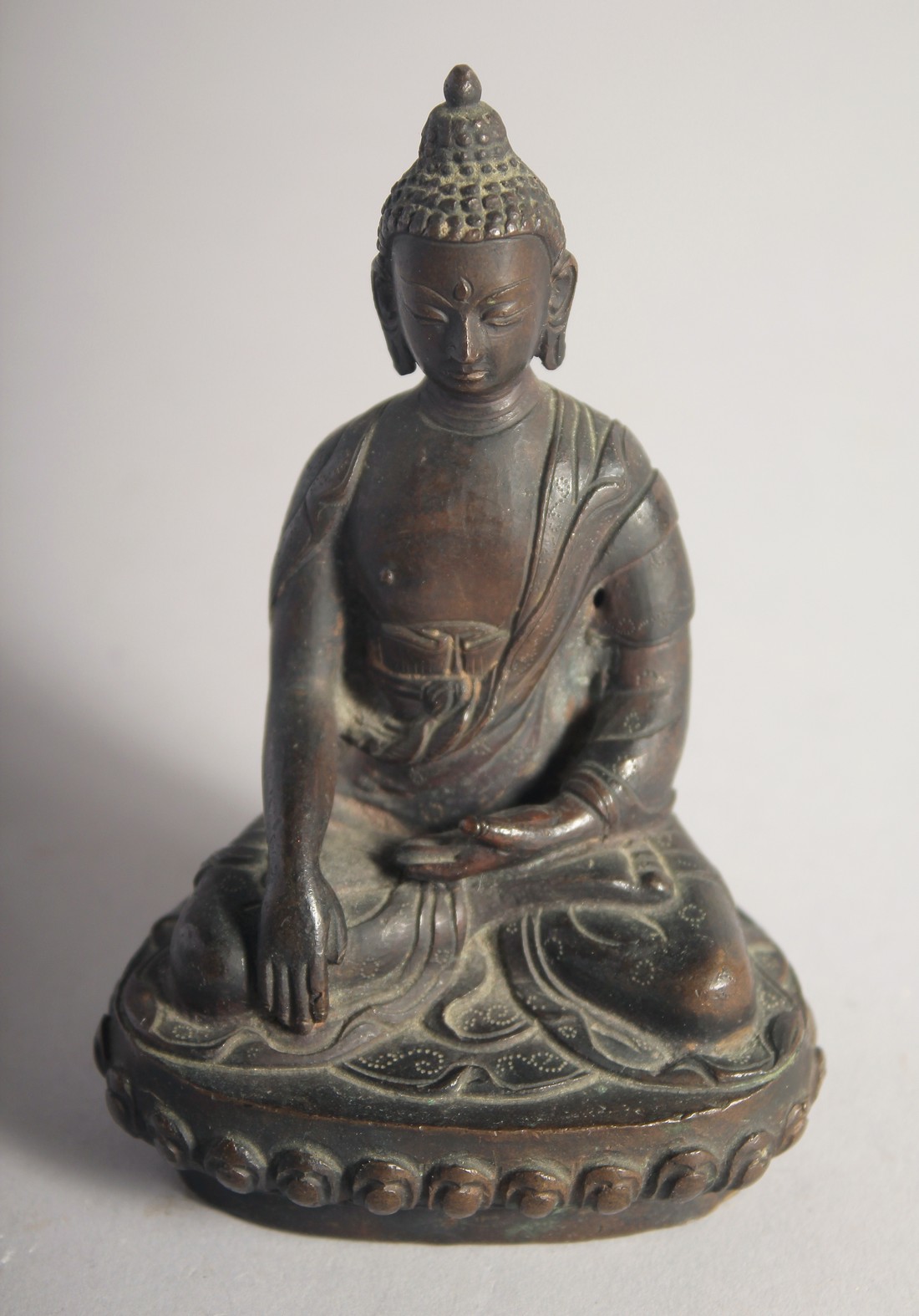 A FINE 18TH/19TH CENTURY INDIAN OR NEPALESE BRONZE BUDDHA, inscribed to the reverse. 10.5cm high