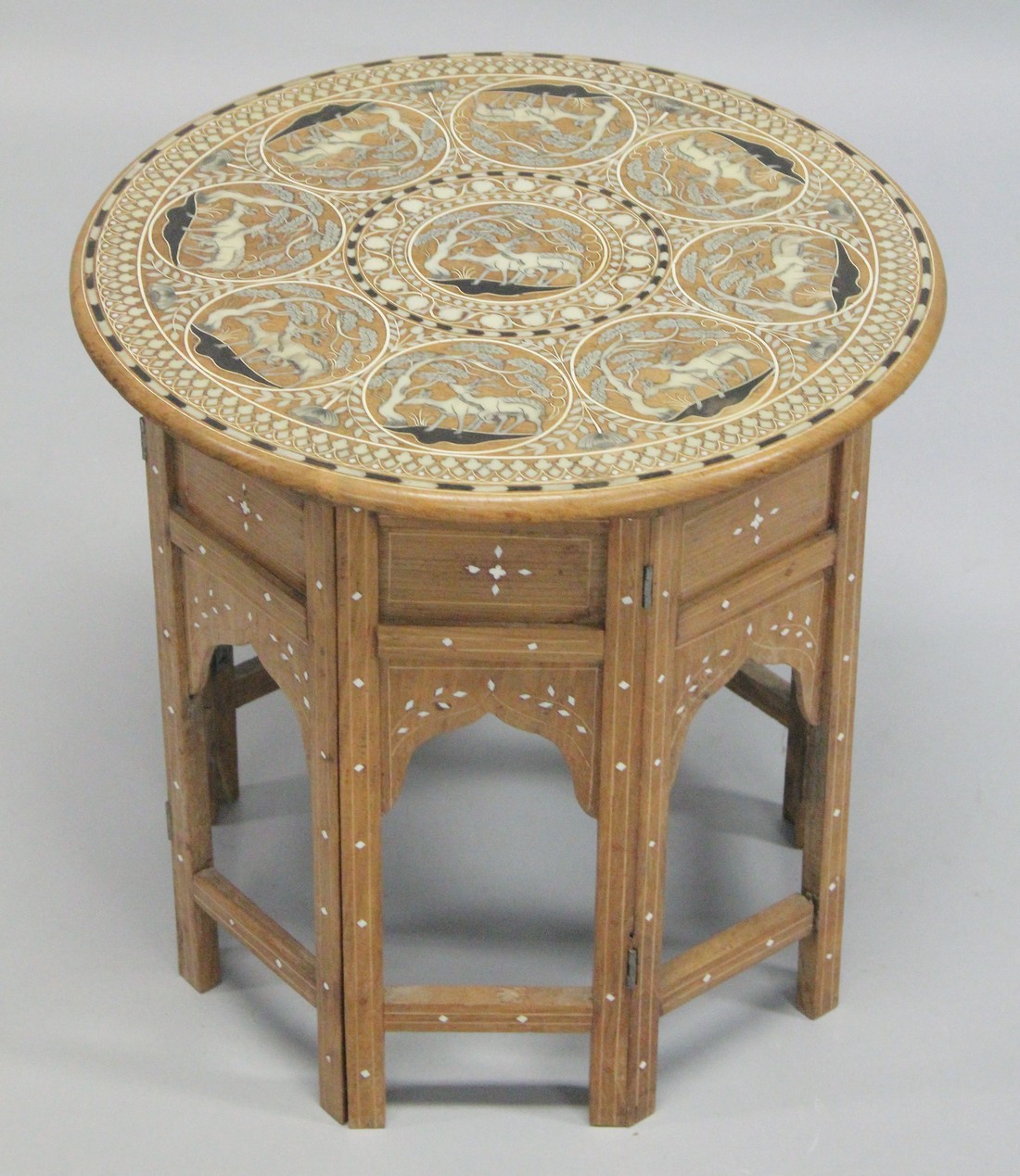 A GOOD AND UNUSUAL INDIAN BONE INLAID CIRCULAR HARDWOOD TABLE, with folding base, the top inlaid