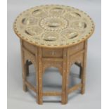 A GOOD AND UNUSUAL INDIAN BONE INLAID CIRCULAR HARDWOOD TABLE, with folding base, the top inlaid