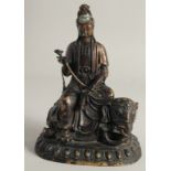 A CHINESE BRONZE FIGURE OF GUANYIN seated on an elephant, 26cm high.
