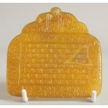 A FINE ISLAMIC YELLOW AGATE INSCRIBED TABLET, with very finely engraved calligraphy, 8.5cm x 8.5cm.