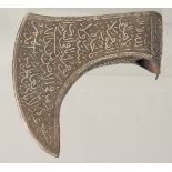 AN ISLAMIC STEEL AXE HEAD, with silver inlaid calligraphy, 21cm at the widest point.
