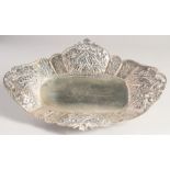 A SILVER LOZENGE SHAPED DISH, with embossed and pierced border, flower head motifs on four curving