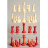 A COLLECTION OF CARVED AND STAINED BONE CHESS PIECES.