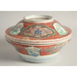 A JAPANESE ARITA PORCELAIN CIRCULAR LIDDED TUREEN, painted with panels of birds and flora, 26.5cm