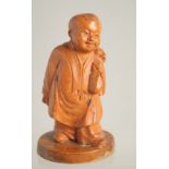 A SMALL CHINESE REPUBLICAN CARVED BOXWOOD FIGURE of a boy, 9.5cm high.