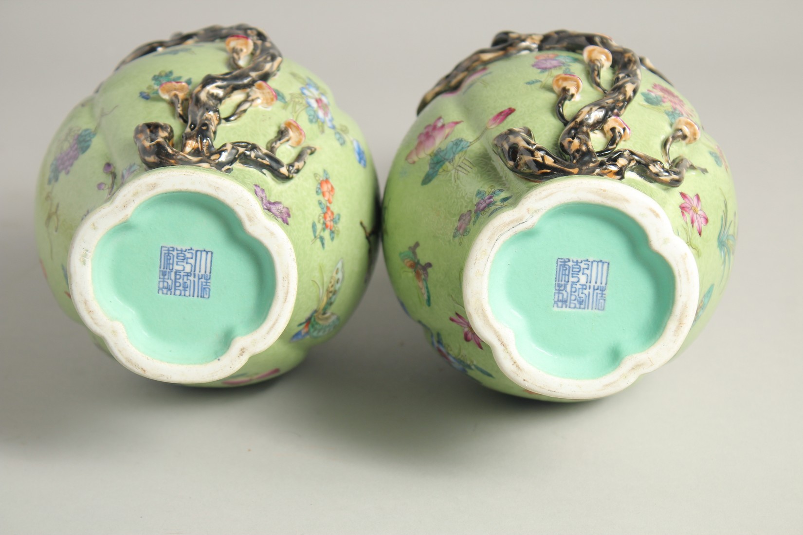 A PAIR OF CHINESE GREEN GROUND PORCELAIN VASES, with relief peach blossom and further decorated with - Image 6 of 8