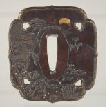 A JAPANESE BRONZE TSUBA, with raised decoration to both sides depicting landscapes with gilt
