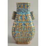 A CHINESE TURQUOISE GROUND GILDED TWIN HANDLE VASE, with blue and turquoise ground and raised