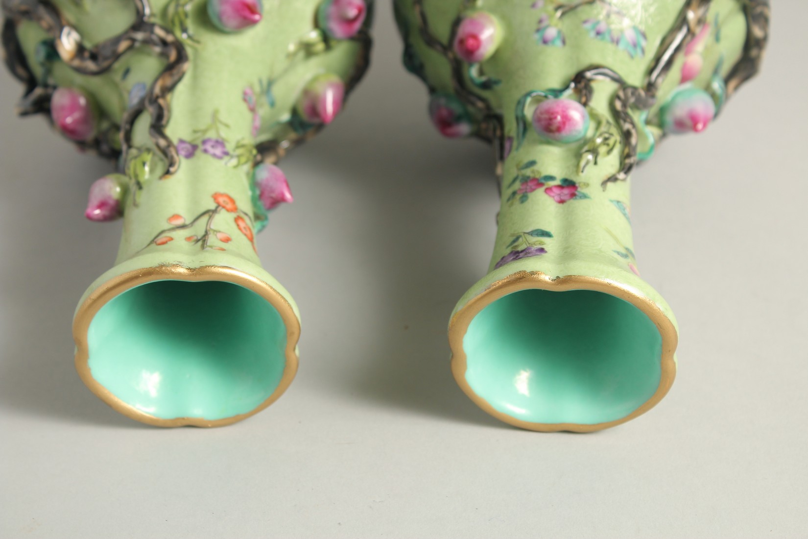 A PAIR OF CHINESE GREEN GROUND PORCELAIN VASES, with relief peach blossom and further decorated with - Image 5 of 8