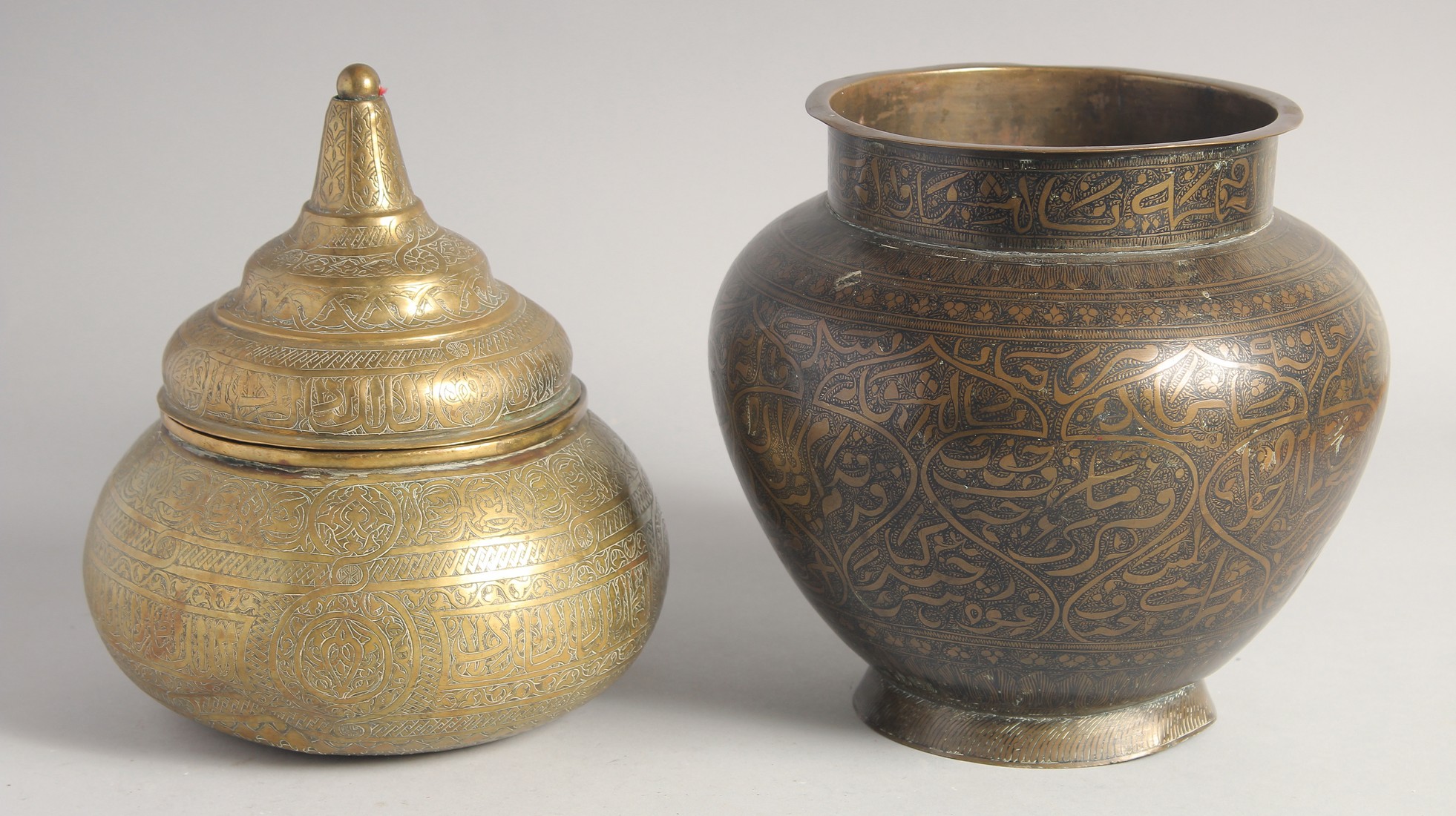 A 19TH CENTURY BLACK ENAMELLED BRASS CALLIGRAPHIC VASE. 21cm high, together with AN ISLAMIC ENGRAVED