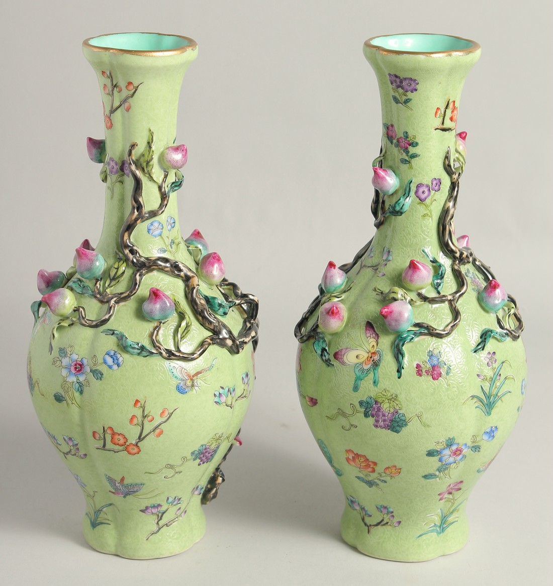 A PAIR OF CHINESE GREEN GROUND PORCELAIN VASES, with relief peach blossom and further decorated with - Image 2 of 8
