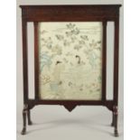 A CHINESE EMBROIDERED SILK PICTURE, framed within a hardwood fire screen, the embroidered image