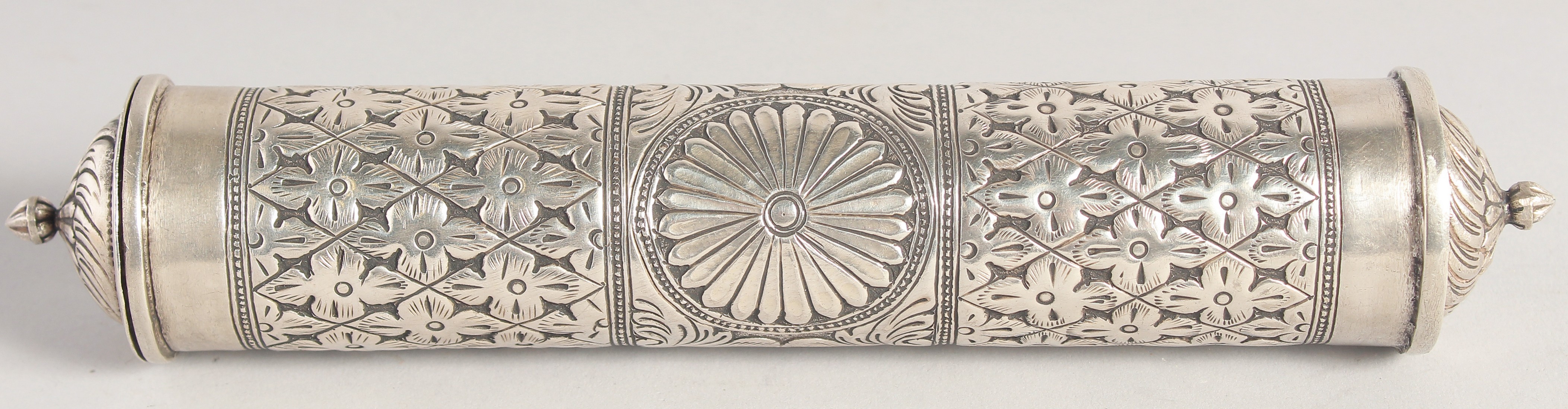 AN ISLAMIC WHITE METAL CYLINDRICAL QURAN / SCROLL CASE, with repousse stylised flower head