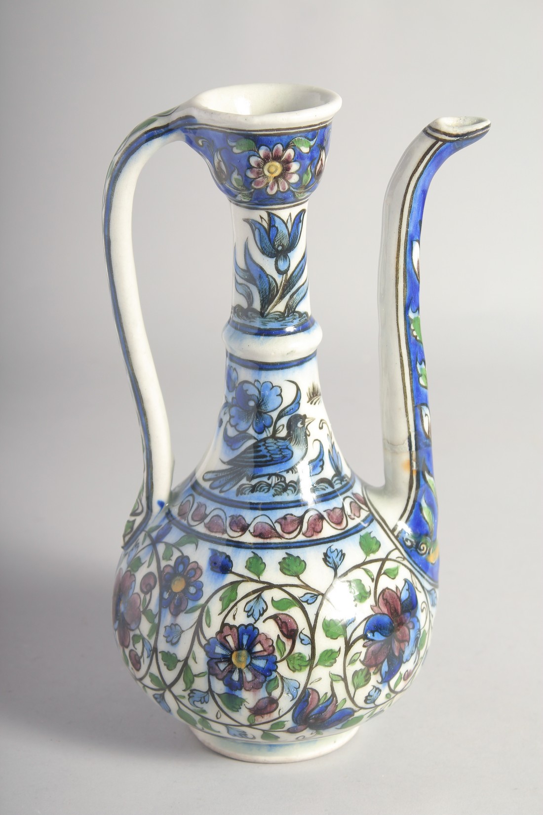 A 19TH CENTURY PERSIAN QAJAR GLAZED POTTERY EWER, painted with birds, flower heads, and scrolling - Image 3 of 6