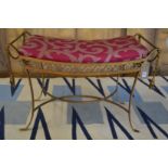 A wrought iron stool with gilded decoration.