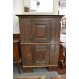 A 17th century and later carved oak livery cupboard with two panelled doors.