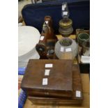 Two sewing boxes, a tantalus frame and an oil lamp.