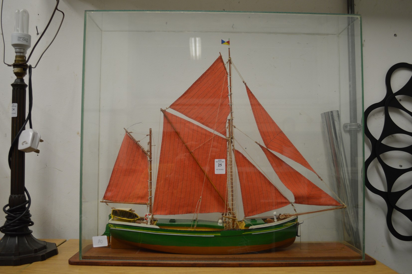 A model sailing ship in a glass case.