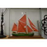 A model sailing ship in a glass case.