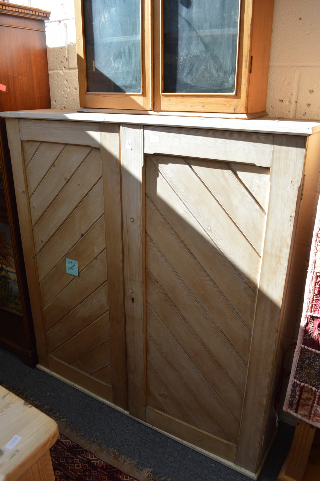 A Victorian pine two-door cupboard.