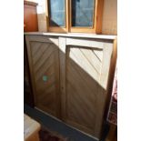 A Victorian pine two-door cupboard.