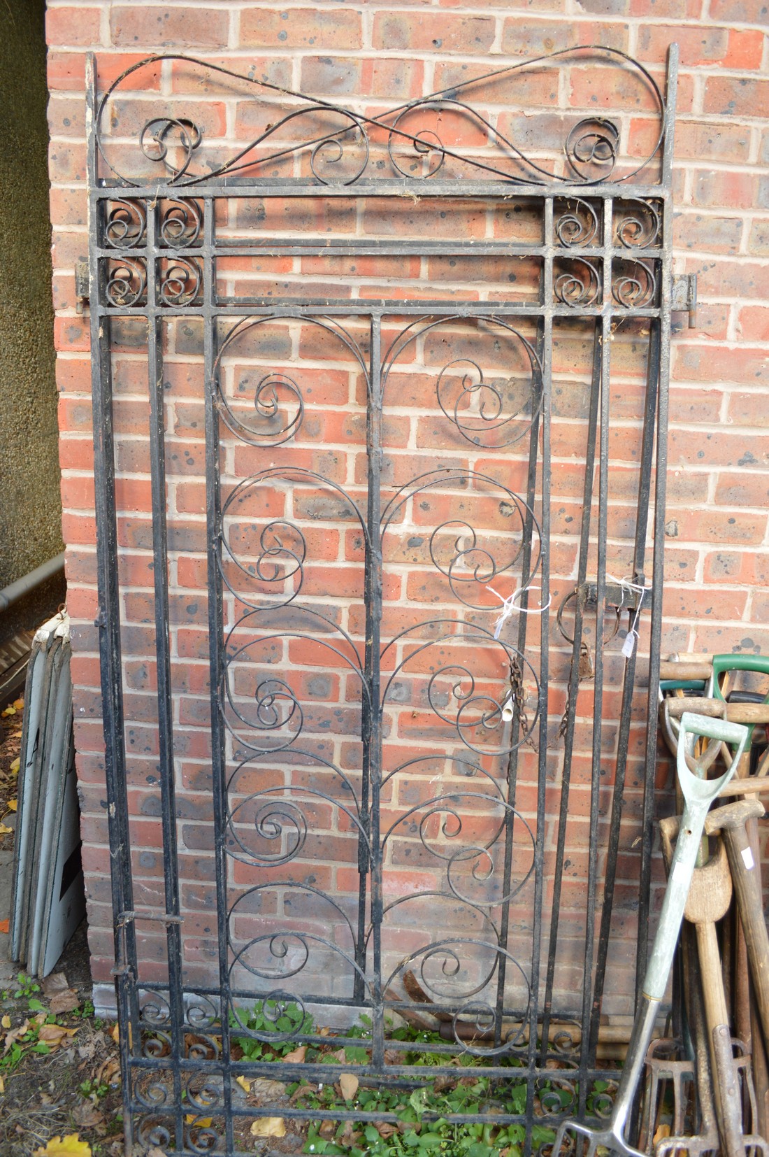 A pair of wrought iron gates, maximum size each 260cms high x 100cms wide excluding hinge brackets.