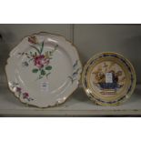 A tin glazed dish painted with flowers and another smaller dish.