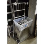 A chrome Victorian style towel rail, two radiators and ancillary equipment including mixer taps.