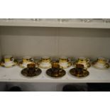 A set of six Aynsley coffee cans and saucers and three gilt decorated coffee cans and saucers.