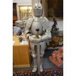 A reproduction life size suit of armour, complete with sword.