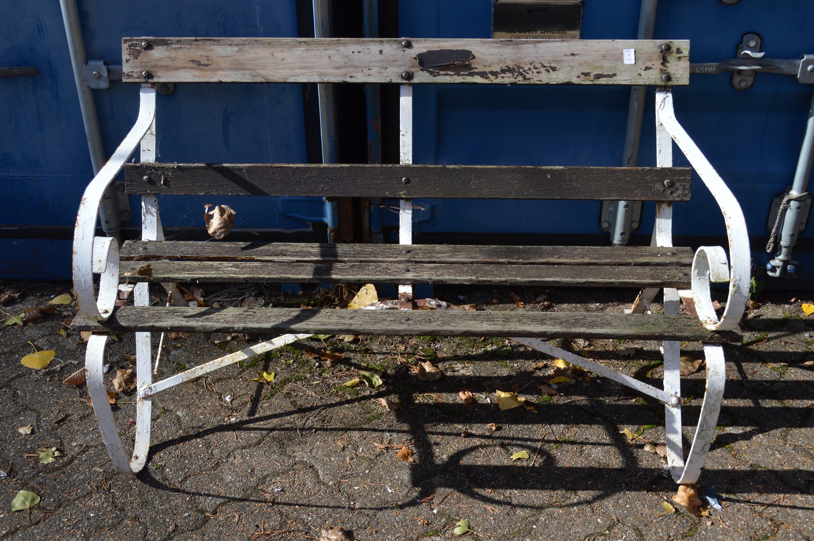 A garden bench with a wrought iron frame.