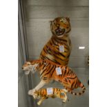 Three porcelain models of tigers.