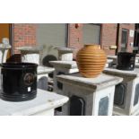 A pair of black glazed garden pots and a ribbed terracotta pot.