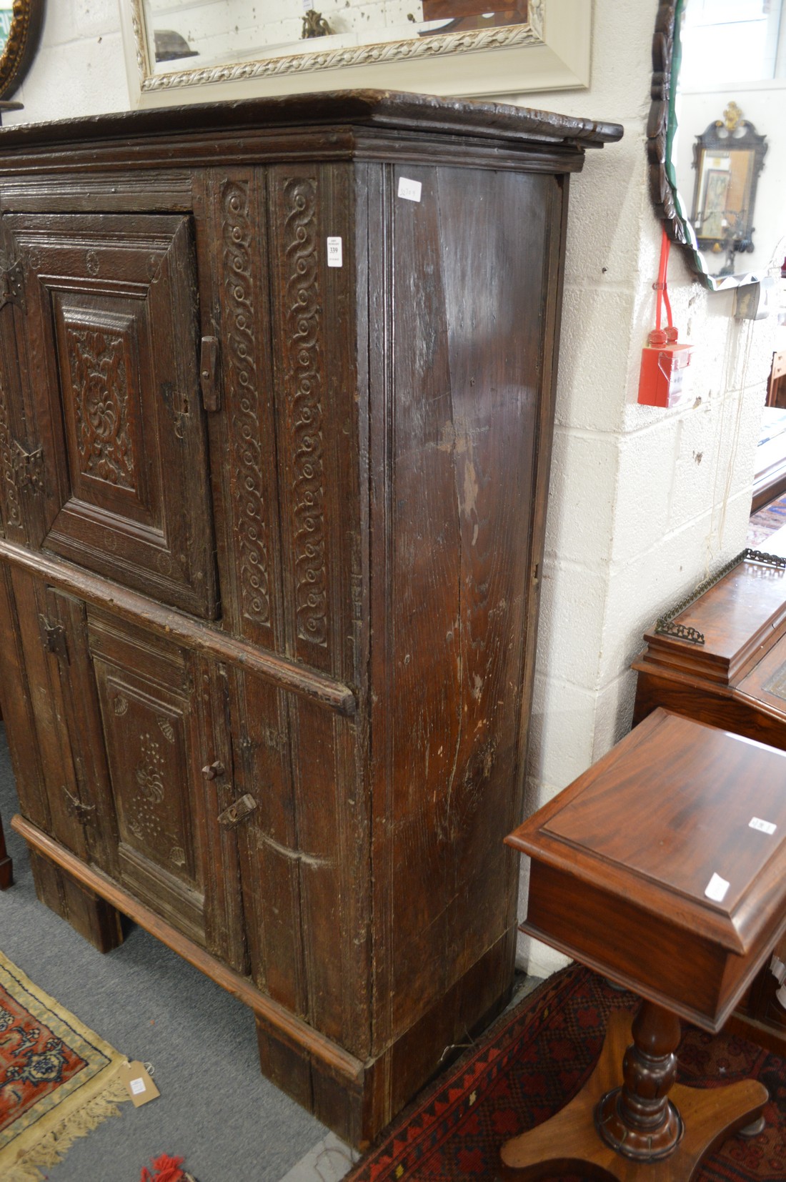 A 17th century and later carved oak livery cupboard with two panelled doors. - Image 2 of 3