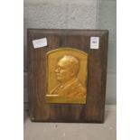 A small relief cast gilt brass portrait plaque.