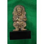 A small Indian bronze god on a marble base.
