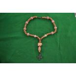 A wooden bead rosary.