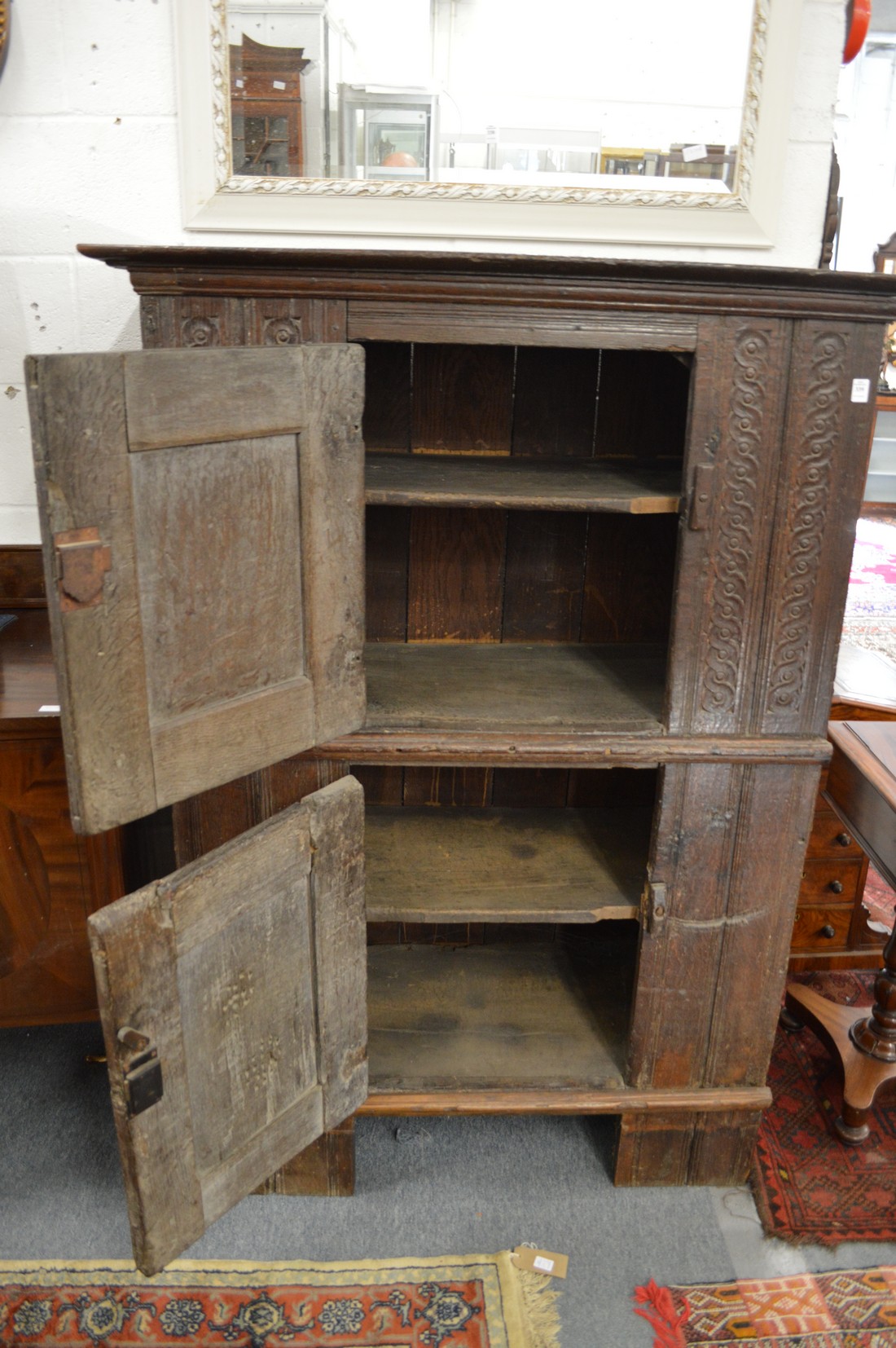 A 17th century and later carved oak livery cupboard with two panelled doors. - Image 3 of 3