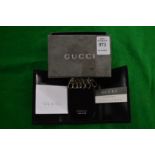 A Gucci key fob, boxed.