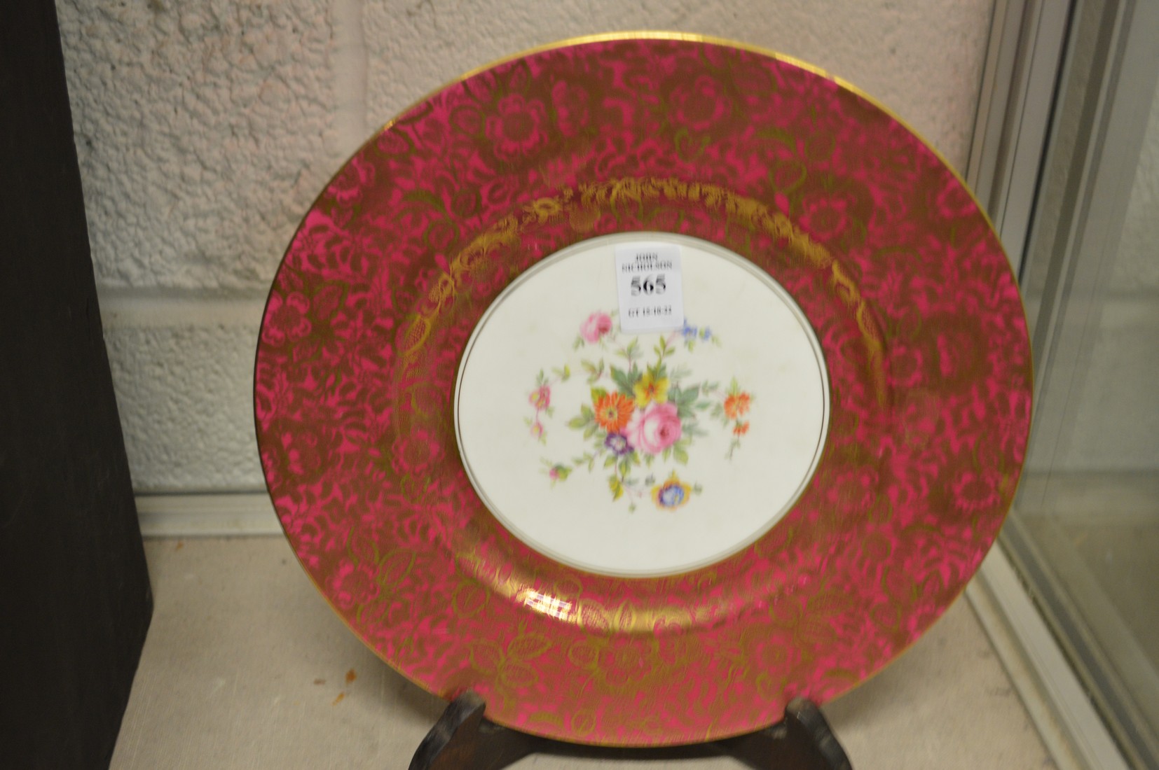 A Minton floral and gilt decorated plate with stand.
