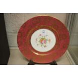 A Minton floral and gilt decorated plate with stand.