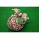 An unusual porcelain inkwell modelled as a nest with a bird and eggs being attacked by a snake.