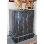 A faux marble pedestal stand.